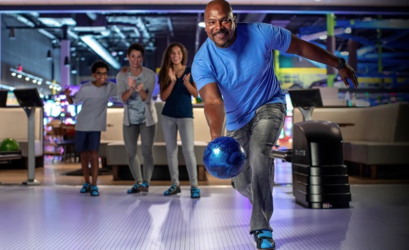 man bowling with family